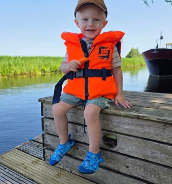 Boy wearing Dotty Fish swim shoes