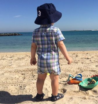 Small boy on beach wearing Dotty Fish sandals