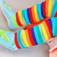 Baby wearing rainbow stripes legwarmers from Dotty Fish 