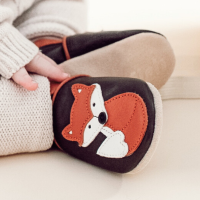 Dotty Fish soft leather baby shoes with fox motif worn by baby