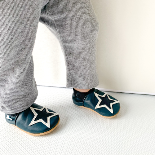 Toddler wearing navy and white star soft leather baby shoes from Dotty Fish 