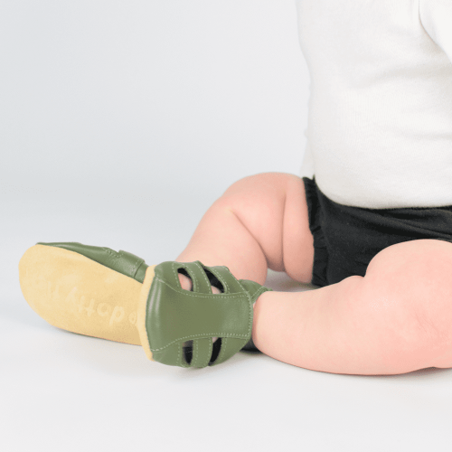 Little baby wearing khaki green soft leather baby sandals from Dotty Fish