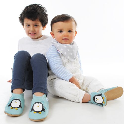 Children wearing penguin motif soft leather slipper by Dotty Fish 