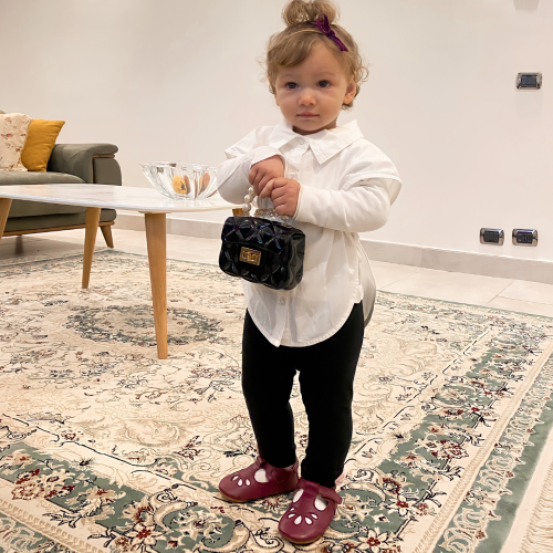 Toddler wearing Classic Emily Plum T-bar shoes from Dotty Fish 