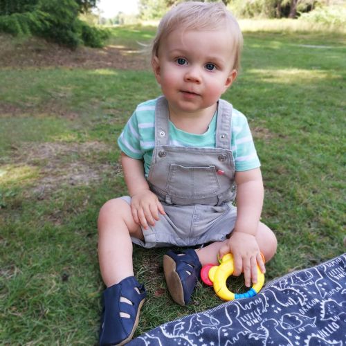 Little boy outside while wearing navy blue sandals from Dotty Fish 