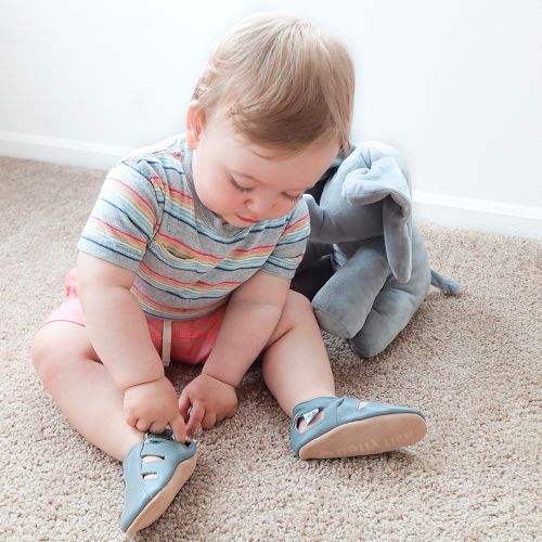Baby sitting wearing grey soft leather baby sandals from Dotty Fish 