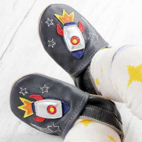 Baby boy wearing charcoal Dotty Fish shoes with silver space rocket design.
