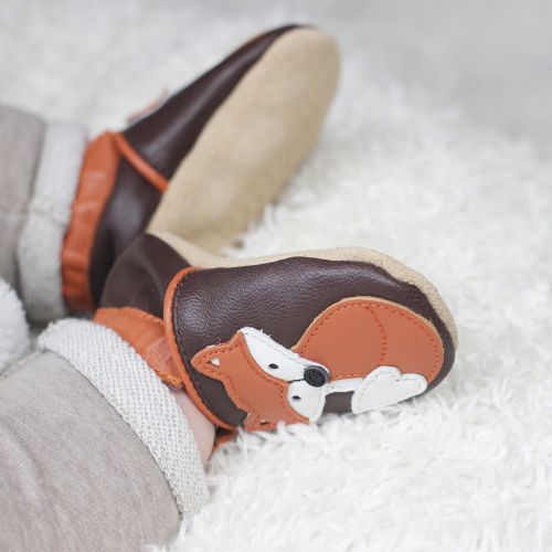 Baby wearing brown leather baby shoes with Freddie fox design from Dotty Fish 