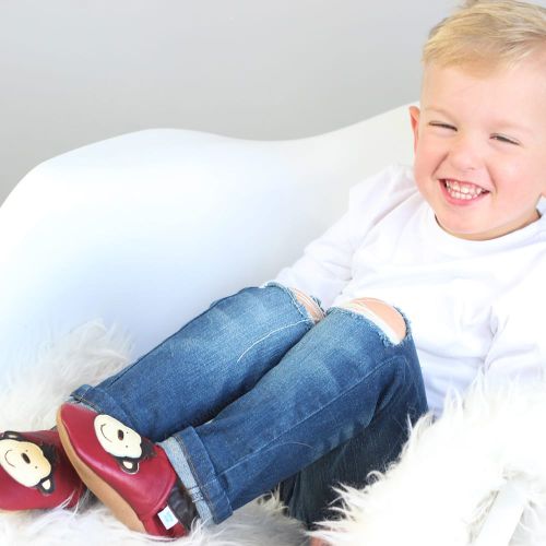 Little boy wearing cheeky monkey red leather slippers from Dotty Fish 