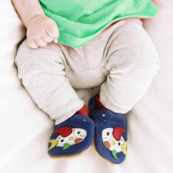 Baby wearing blue leather baby shoes with colourful fish motif from Dotty Fish 