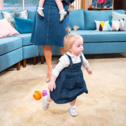 Toddler wearing silver leather Dotty Fish baby and toddler girl’s soft sole T-bar shoes.