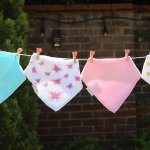 Machine washable baby bibs by Dotty Fish hanging on a washing line
