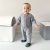 Toddler boy standing wearing navy blue leather Dotty Fish first walker shoes with white and navy star design.