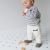 Toddler standing, wearing plain grey leather shoes from Dotty Fish.
