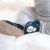 Baby boy sitting, wearing navy Dotty Fish barefoot shoes with white snowman wearing black hat and embroidered rainbow scarf design.