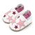 White leather Dotty Fish soft sole pre-walker shoes with pink ankle trim and pink stars.
