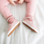 Little girl wearing Dotty Fish pink leather pre-walker rubber sole slip-on shoes.