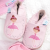 Pink leather ballerina shoes in drawer with baby clothing.