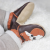 Toddler wearing brown leather Dotty Fish first walker shoes with orange and white fox design.