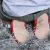 Toddler kneeling on floor showing suede soles of Dotty Fish shoes.