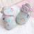 Pale blue cotton baby booties, with blanket.
