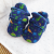 Blue dinosaur baby booties, sitting on baby blanket.
