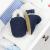 Navy suede slippers in open drawer, with baby blankets.