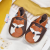 Leather baby shoes with fox design, in drawer with baby clothing.