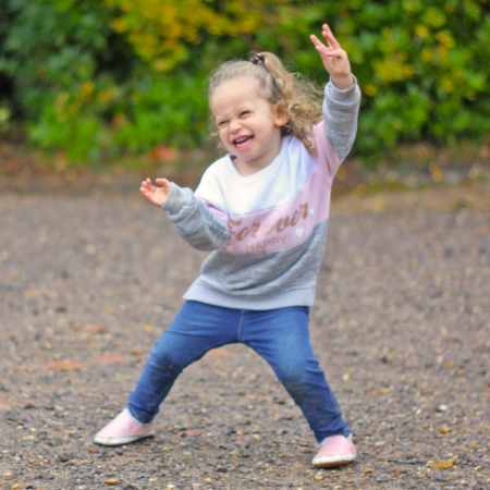 Smiling little girl on her way back from pre-school