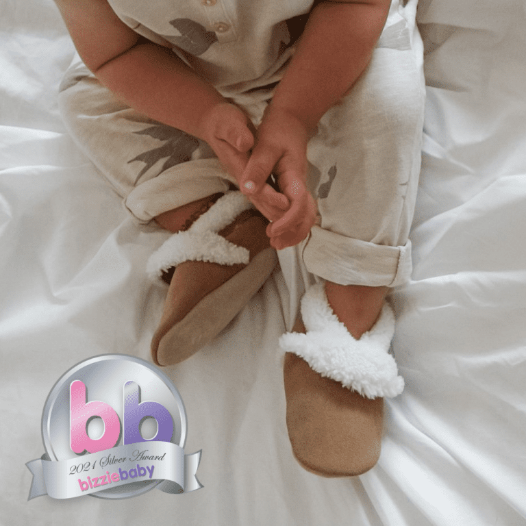 Dotty Fish tan suede slippers with white fleece lining.