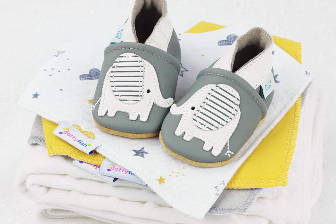 Grey leather baby shoes with elephant design.