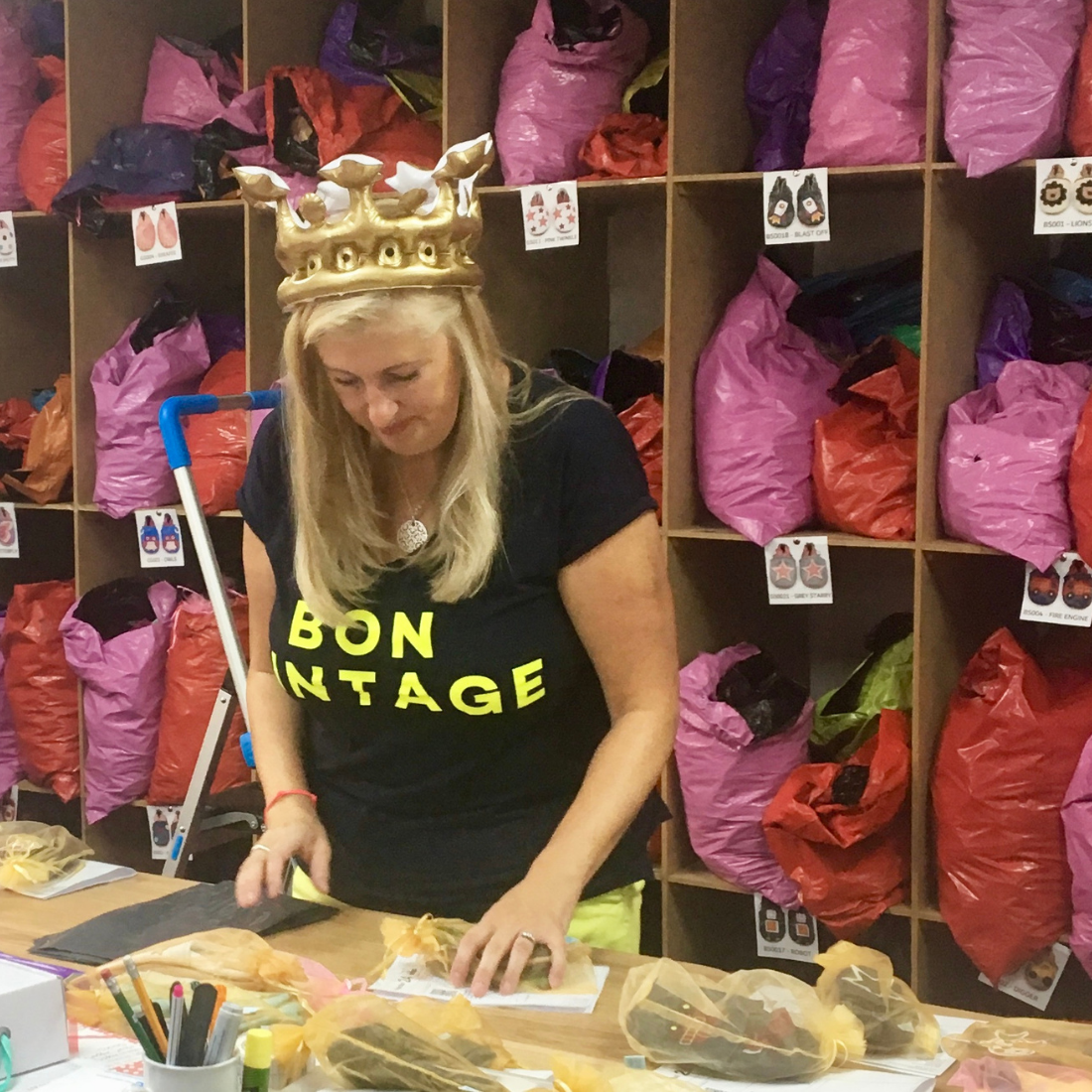 Dotty Fish owner, Helen, packing customer orders of baby shoes.